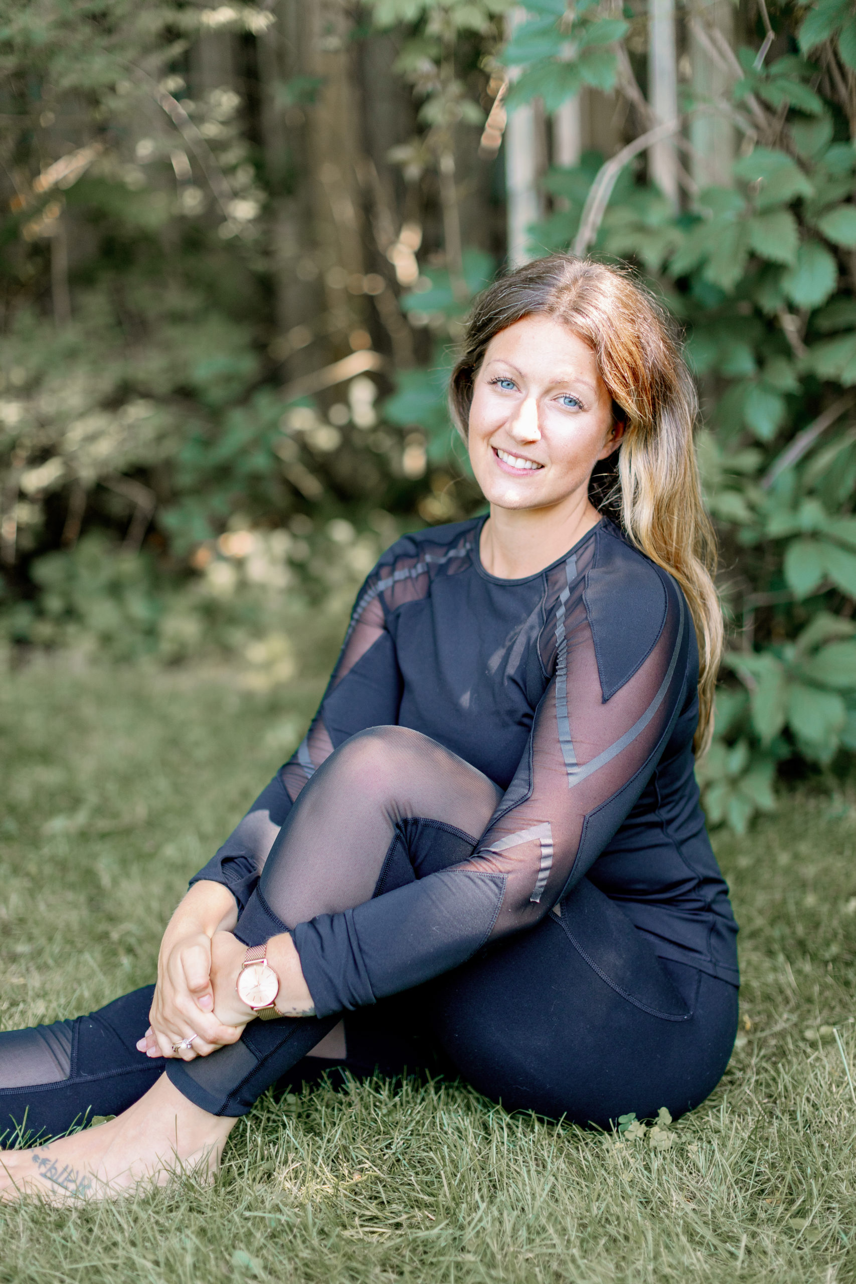 Lisa sitting in front of trees
